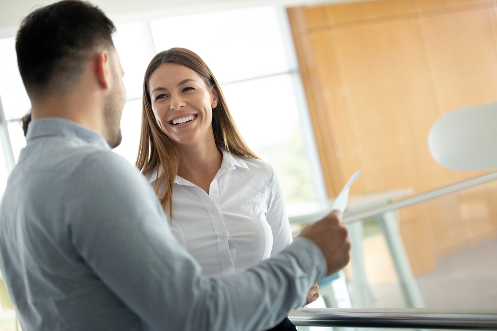 Woman and man in office laughing smiling together