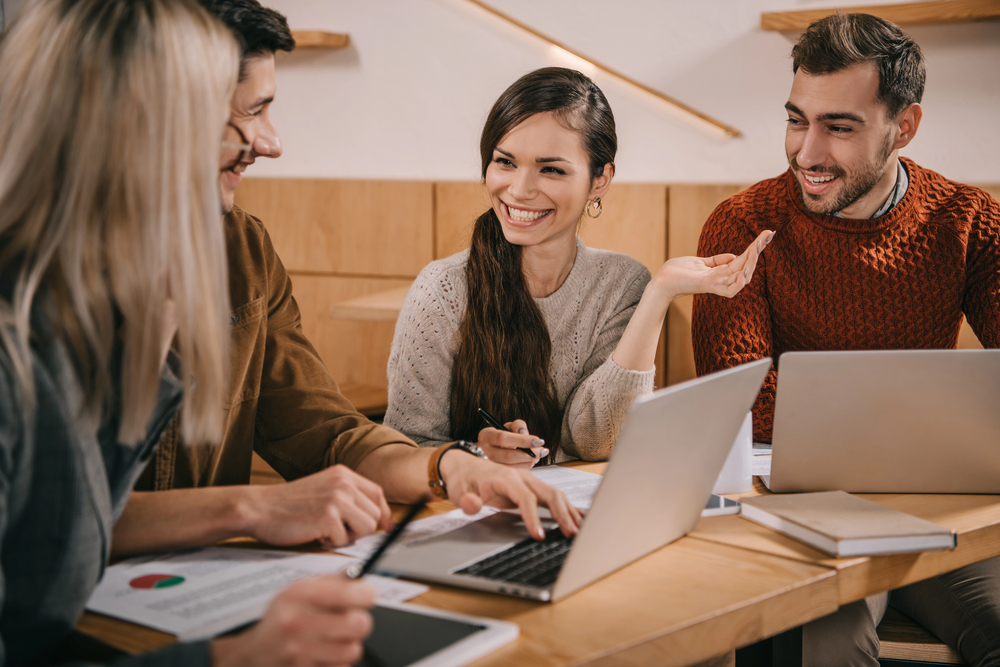 People chatting and laughing together in office